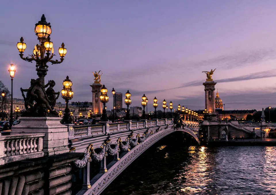 An ornate bridge crossing the Seine in Paris at dusk